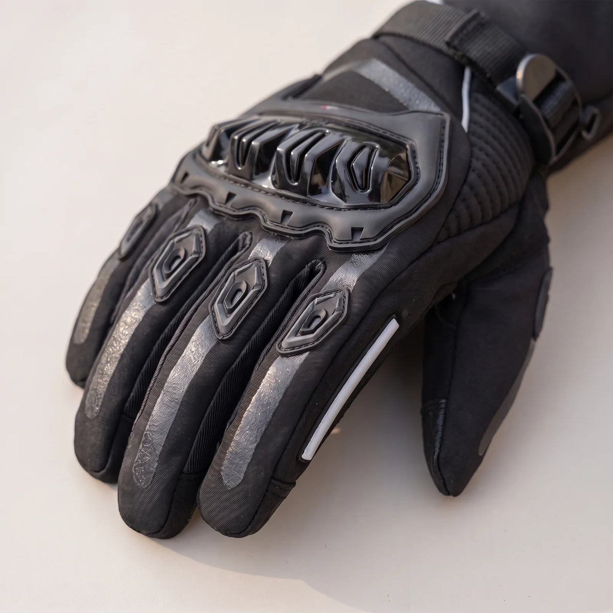 Back of the hand with hard knuckle guard, padded finger protectors and reflective strip