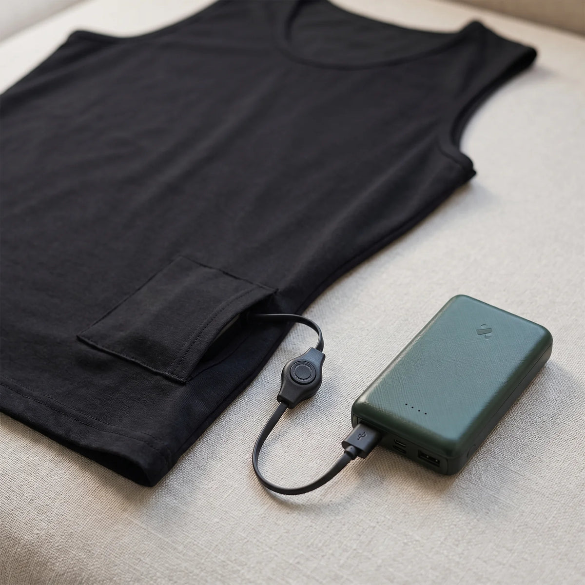 Pocket at the hem with cable switch and the BergHeat Power Bank plugged in